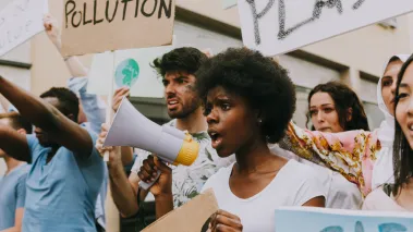 student protesters holding bullhorns and signs